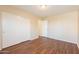 A bedroom featuring wood floors and a closet with sliding white doors at 4010 W Fremont Rd, Phoenix, AZ 85041