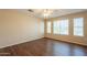 Bright bedroom featuring wood-look flooring, a ceiling fan, and multiple windows at 4010 W Fremont Rd, Phoenix, AZ 85041