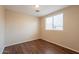 A cozy bedroom featuring wood floors and a bright window at 4010 W Fremont Rd, Phoenix, AZ 85041