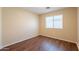Bedroom showcasing wood floors and a window with neutral-colored walls at 4010 W Fremont Rd, Phoenix, AZ 85041