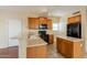 Kitchen with wood cabinets, stone countertops, and black appliances at 4010 W Fremont Rd, Phoenix, AZ 85041