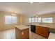 Open kitchen features wood cabinets, an island, and a tile floor at 4010 W Fremont Rd, Phoenix, AZ 85041