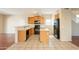 Eat-in kitchen includes wood cabinets and black appliances with an eat-in counter at 4010 W Fremont Rd, Phoenix, AZ 85041