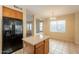 Open kitchen includes wood cabinets, an island, and tile floors at 4010 W Fremont Rd, Phoenix, AZ 85041