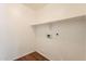 A laundry room with shelving, utility hookups, and white walls at 4010 W Fremont Rd, Phoenix, AZ 85041