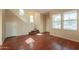 Open-concept living room with wood floors, staircase, and multiple windows providing ample natural light at 4010 W Fremont Rd, Phoenix, AZ 85041