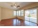 Bright living room features wood floors, ceiling fan, and a sliding glass door to the backyard at 4010 W Fremont Rd, Phoenix, AZ 85041