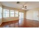 Spacious living room featuring wood floors, a ceiling fan, and sliding glass doors to the outdoor space at 4010 W Fremont Rd, Phoenix, AZ 85041