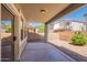 Covered patio featuring mature landscaping, neutral paint, and a privacy wall at 4010 W Fremont Rd, Phoenix, AZ 85041