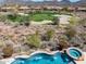 Aerial view showcasing the pool and golf course in this desert home's backyard at 41819 N Anthem Ridge Dr, Phoenix, AZ 85086