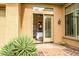 Bedroom entrance with tan walls, glass paneled french doors, and desert landscaping at 41819 N Anthem Ridge Dr, Phoenix, AZ 85086