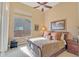 Cozy bedroom with a ceiling fan, neutral color palette, and ample natural light at 41819 N Anthem Ridge Dr, Phoenix, AZ 85086