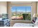 Comfortable bedroom features a large window with stunning views of the outdoor patio and mountains at 41819 N Anthem Ridge Dr, Phoenix, AZ 85086