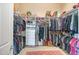 Walk in closet offering ample storage, built in shelving, rods and drawer space at 41819 N Anthem Ridge Dr, Phoenix, AZ 85086