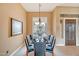 Formal dining room featuring a decorative chandelier, large window, and seating for eight at 41819 N Anthem Ridge Dr, Phoenix, AZ 85086