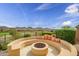 Cozy outdoor fire pit with built-in seating, offering a perfect spot for enjoying the mountain views at 41819 N Anthem Ridge Dr, Phoenix, AZ 85086