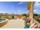 Landscaped backyard with built-in seating, firepit, hot tub, and scenic views at 41819 N Anthem Ridge Dr, Phoenix, AZ 85086