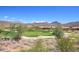 Scenic view of the golf course with lush greenery and beautiful mountain views in the background at 41819 N Anthem Ridge Dr, Phoenix, AZ 85086