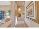 Inviting hallway with niche, tiled flooring, decorative art, and views of the living area at 41819 N Anthem Ridge Dr, Phoenix, AZ 85086