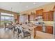 Inviting kitchen with a spacious island, bar stool seating, stainless appliances, and wood cabinets at 41819 N Anthem Ridge Dr, Phoenix, AZ 85086