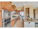 Gourmet kitchen with stainless steel appliances, custom wood cabinetry, and a large kitchen island at 41819 N Anthem Ridge Dr, Phoenix, AZ 85086