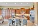 Spacious kitchen with stainless appliances, kitchen island, breakfast bar, and wooden cabinetry at 41819 N Anthem Ridge Dr, Phoenix, AZ 85086