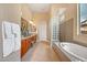 Luxurious main bathroom with double vanities, a soaking tub, and natural light at 41819 N Anthem Ridge Dr, Phoenix, AZ 85086