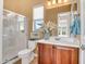 Bright bathroom featuring a glass shower, decorative mirror, and white countertop at 41819 N Anthem Ridge Dr, Phoenix, AZ 85086