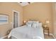 Bright bedroom with ceiling fan, white bedding, and neutral walls at 41819 N Anthem Ridge Dr, Phoenix, AZ 85086