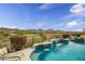 Inviting pool with waterfall feature overlooking a golf course and mountain views at 41819 N Anthem Ridge Dr, Phoenix, AZ 85086