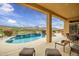 Backyard pool with waterfall feature, hot tub, mountain views, and outdoor seating at 41819 N Anthem Ridge Dr, Phoenix, AZ 85086