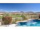 Inviting pool with waterfall feature overlooking a golf course in the desert at 41819 N Anthem Ridge Dr, Phoenix, AZ 85086