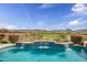 Inviting pool with a view of the manicured golf course and mountains in the distance at 41819 N Anthem Ridge Dr, Phoenix, AZ 85086