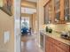 Stylish wet bar area with custom cabinetry, a wine cooler, and granite countertops at 41819 N Anthem Ridge Dr, Phoenix, AZ 85086