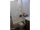 A well-lit bathroom with a shower/tub combo, white tile walls, and basic fixtures at 4550 W Cinnabar Ave, Glendale, AZ 85302