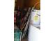 A small water heater, aluminum ladder and cleaning supplies are visible in a storage area at 4550 W Cinnabar Ave, Glendale, AZ 85302