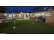 Large backyard includes a putting green, a fire pit, and an outdoor dining space, great for relaxation at 4714 N Miller Rd, Scottsdale, AZ 85251