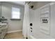 Clean bathroom showcases a tub-shower combo, complemented by sleek fixtures and practical shelving for added convenience at 4714 N Miller Rd, Scottsdale, AZ 85251