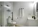 Modern bathroom with glass enclosed shower and sleek white vanity at 4714 N Miller Rd, Scottsdale, AZ 85251