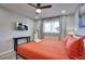 Inviting bedroom with a comfy bed, wood-look floors, a ceiling fan, and a mounted TV, offering a modern and cozy retreat at 4714 N Miller Rd, Scottsdale, AZ 85251