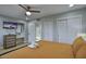 Bright bedroom with modern decor, large closet, and ensuite bathroom entrance at 4714 N Miller Rd, Scottsdale, AZ 85251