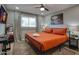 Cozy bedroom featuring a queen bed, a ceiling fan, wood-style floors, and a flatscreen TV for modern comfort at 4714 N Miller Rd, Scottsdale, AZ 85251