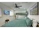 Cozy bedroom featuring a twin over queen bunk bed and wall-mounted television at 4714 N Miller Rd, Scottsdale, AZ 85251
