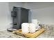 Stylish coffee bar features a modern coffee maker and mugs on a granite countertop at 4714 N Miller Rd, Scottsdale, AZ 85251