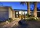 Beautiful brick pathway to front door with unique desert landscaping at dusk at 4714 N Miller Rd, Scottsdale, AZ 85251
