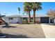 Charming single-story home with desert landscaping and mature palm trees at 4714 N Miller Rd, Scottsdale, AZ 85251