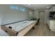 Spacious game room with air hockey table, neon sign, and kitchenette area at 4714 N Miller Rd, Scottsdale, AZ 85251