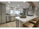 Bright kitchen island with stone countertops and stainless steel appliances at 4714 N Miller Rd, Scottsdale, AZ 85251