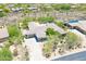This house features desert landscaping, a three car garage, and a tile roof at 6069 E Ironwood Dr, Scottsdale, AZ 85266