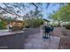 Inviting outdoor patio featuring a built-in grill, desert landscaping, and comfortable seating area at 6069 E Ironwood Dr, Scottsdale, AZ 85266
